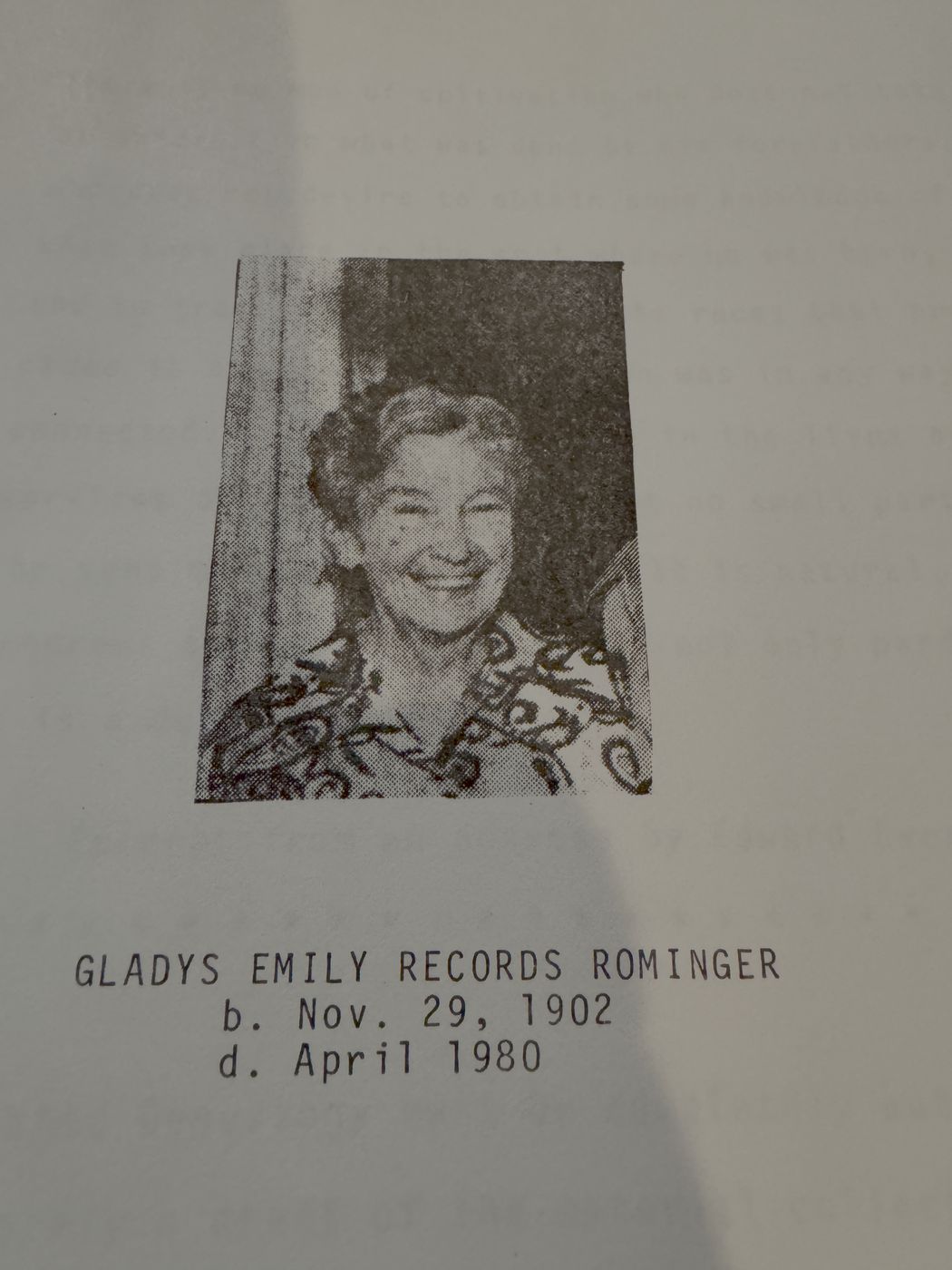 A halftone portrait of a smiling woman; the printed caption gives her name and dates.
